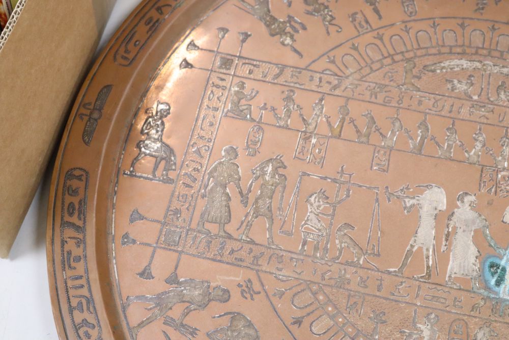 A large circular copper tray with white metal inlay depicting ancient Egyptian scenes, diameter 61cm